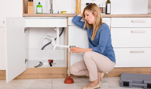 woman working under sink