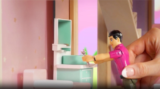 A doll technician looks at a toy sink.