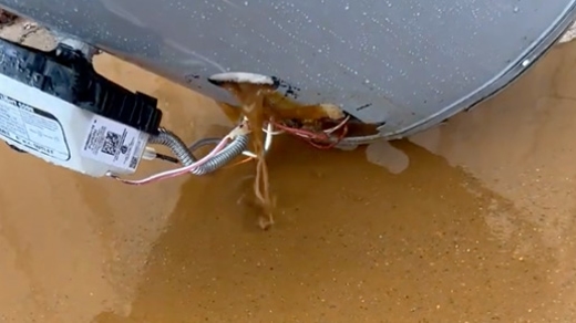 Dirty brown water draining out of a hot water heater.